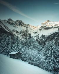 Scenic view of snow covered mountains against sky