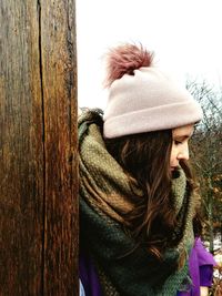 Close-up of woman on snow covered tree