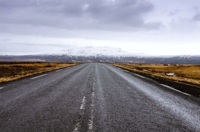 Country road against sky