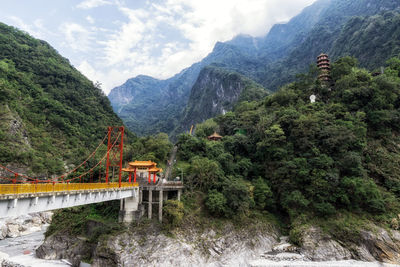 Bridge over mountains against sky