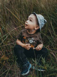 Cute boy looking away on field
