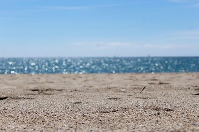 Scenic view of beach against blue sky