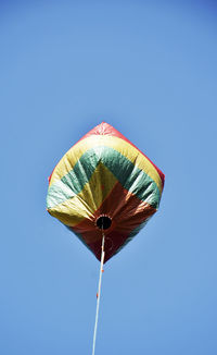 Low angle view of umbrella against blue sky