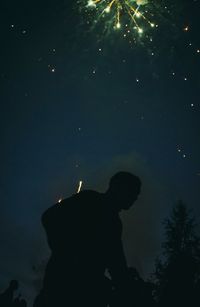 Low angle view of silhouette people at night