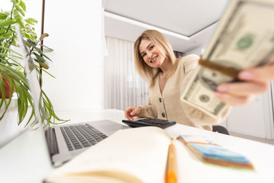 Young woman using laptop on table