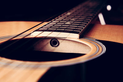 Close-up of guitar against black background