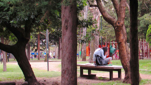 Man sitting on bench in park