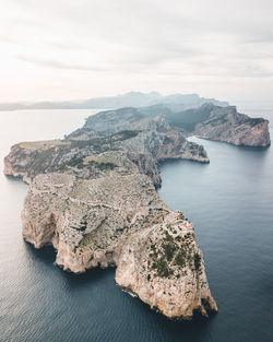 High angle view of rocks in sea against sky