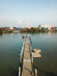 Pier over river against sky