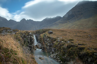 Panoramic view of river amidst mountains against sky