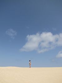 Full length of woman standing against clear sky