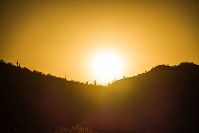 Scenic view of silhouette mountains against sky during sunset