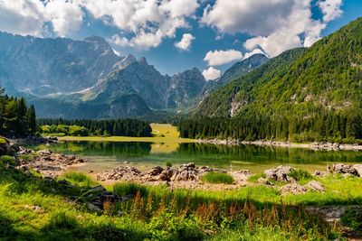 Scenic view of lake and mountains against sky