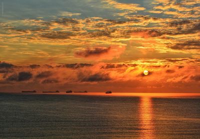 Scenic view of sea against romantic sky at sunset