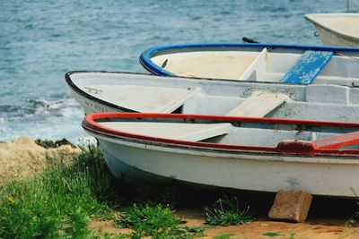 Close-up of boats moored at beach