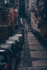 Cobblestone street amidst buildings in city