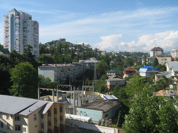 High angle view of houses in town against sky