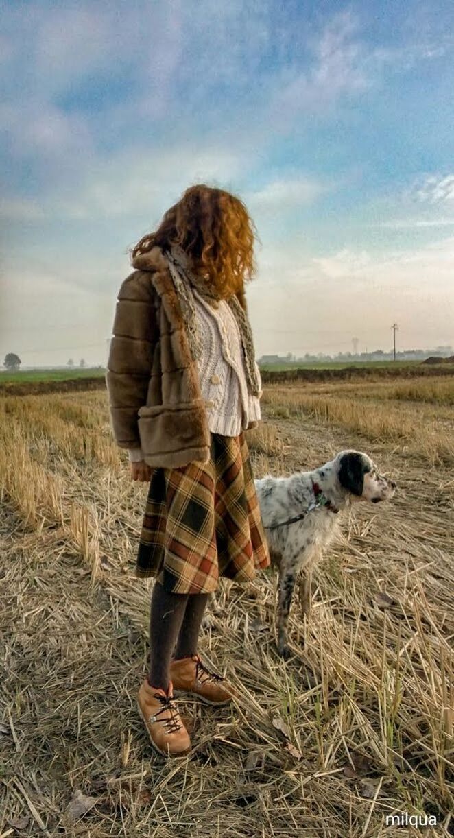 mammal, domestic animals, one animal, pets, domestic, canine, sky, dog, one person, field, full length, land, grass, nature, women, cloud - sky, landscape, adult, hair, pet owner, hairstyle, outdoors