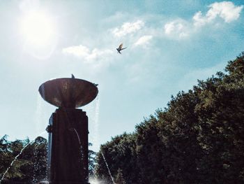 Low angle view of birds flying against sky