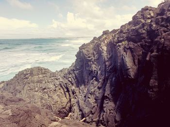 Scenic view of sea against cloudy sky