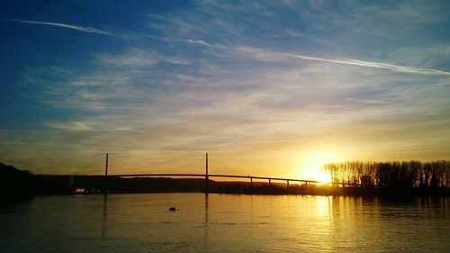 Scenic view of river at sunset