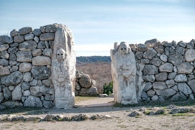 View of stone wall and door  against the sky