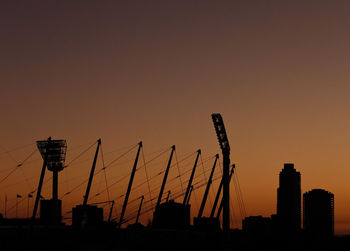 Silhouette stadium against clear sky during sunset