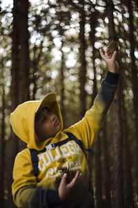 Portrait of boy looking at camera in forest