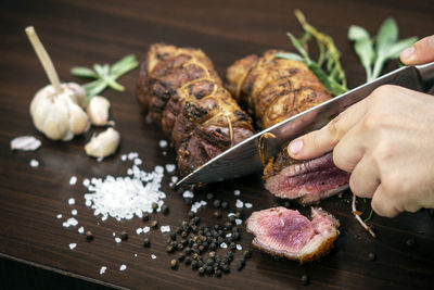 Close-up of hand holding food on table