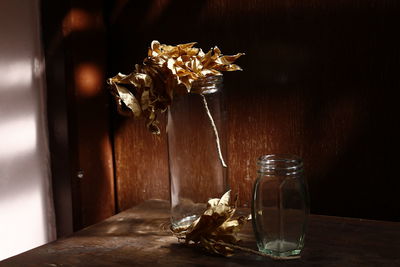 Close-up of wet glass vase on table at home