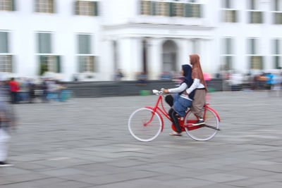 Man riding bicycle on street