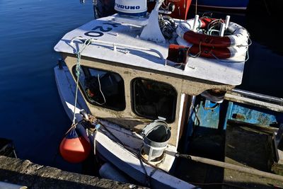 High angle view of fishing boat moored at pier in sea