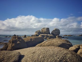 Rocks on beach against sky