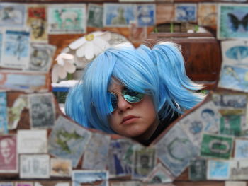 Reflection of dyed hair girl seen in heart shape mirror