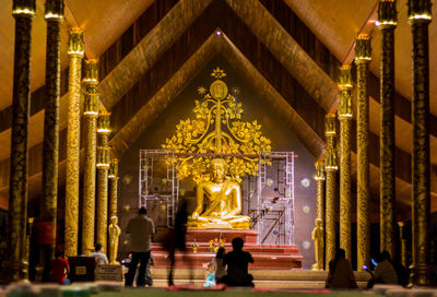 Statue against illuminated building