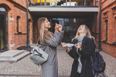 Portrait of young woman using mobile phone