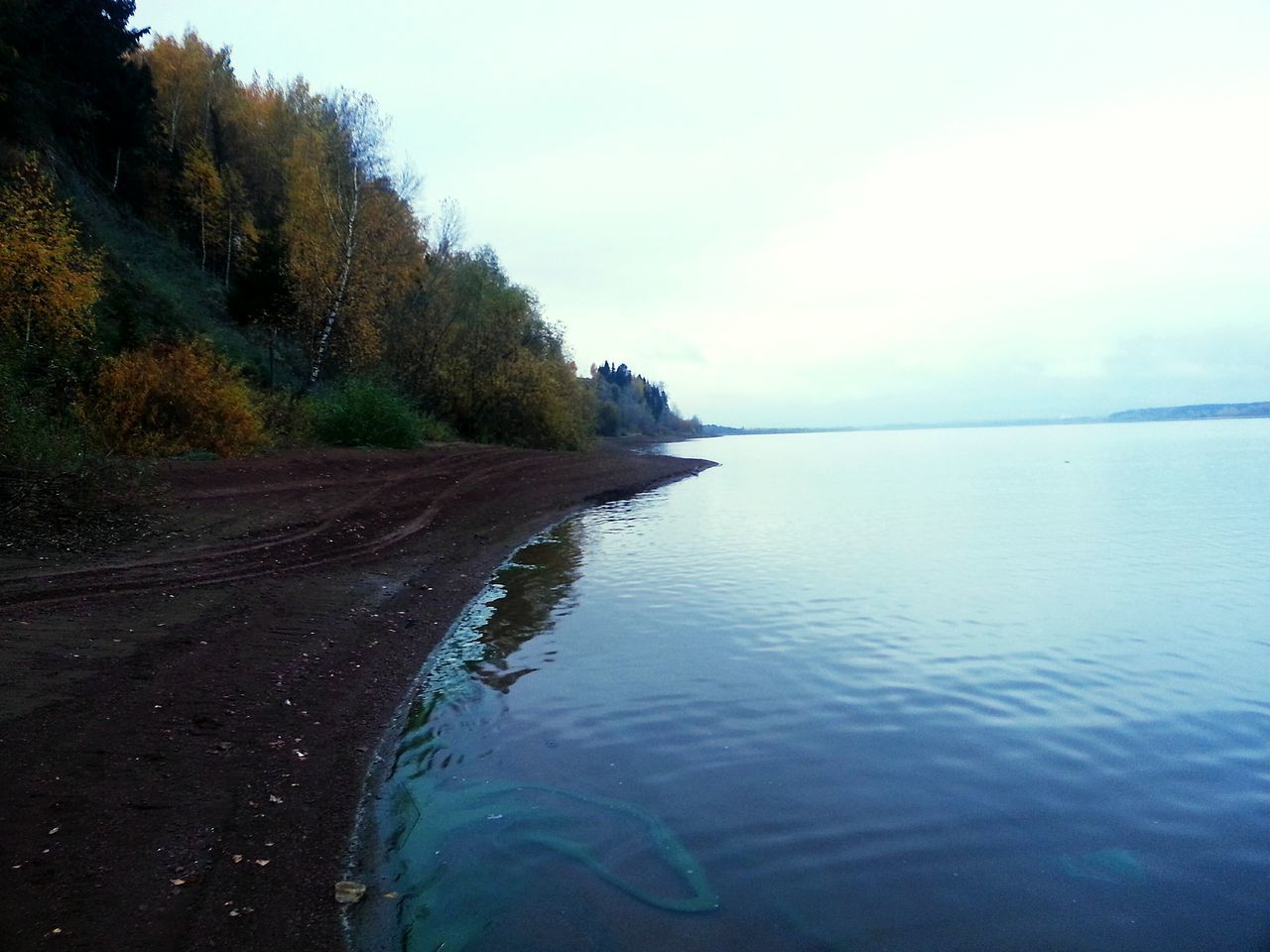 water, tranquil scene, scenics, tranquility, tree, reflection, sea, beauty in nature, waterfront, nature, sky, cloud, non-urban scene, calm, outdoors, day, coastline, no people, mountain road, remote, majestic, seascape