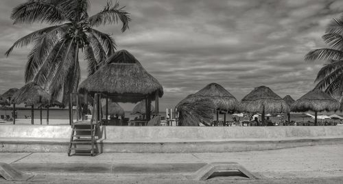 Panoramic view of people on beach against sky