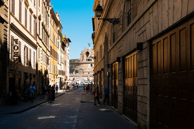 People on street by hadrians tomb in city