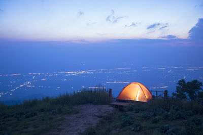 Scenic view of illuminated mountains against sky at night