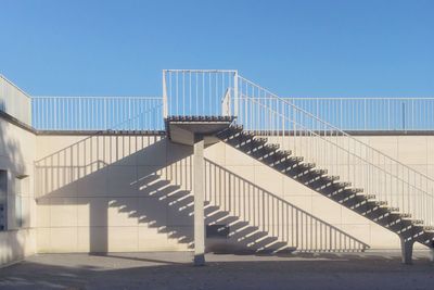 Staircase against clear blue sky