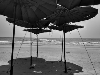 Umbrellas on beach against sky