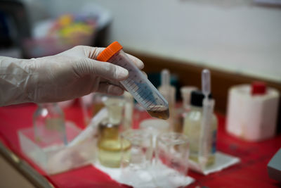 Cropped hand examining in laboratory