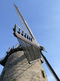 Low angle view of traditional windmill against clear sky