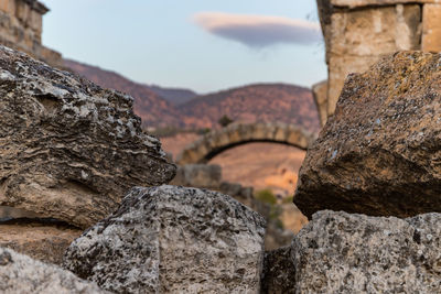 Close-up of rock on mountain against sky