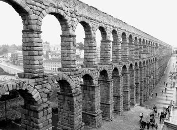 Group of people in old ruins against sky