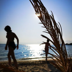 Person at beach against sky