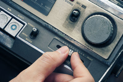 Cropped image of person using vintage radio