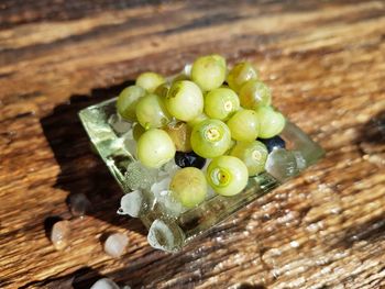 High angle view of grapes in container on table