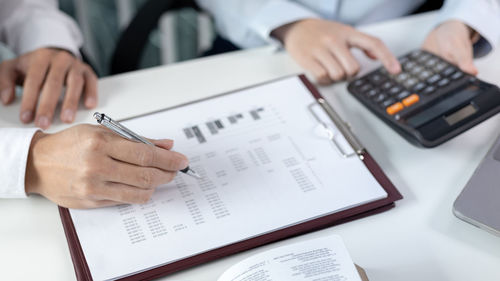 Midsection of businessman working at office